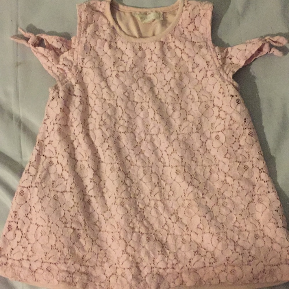 Between pink shirt
